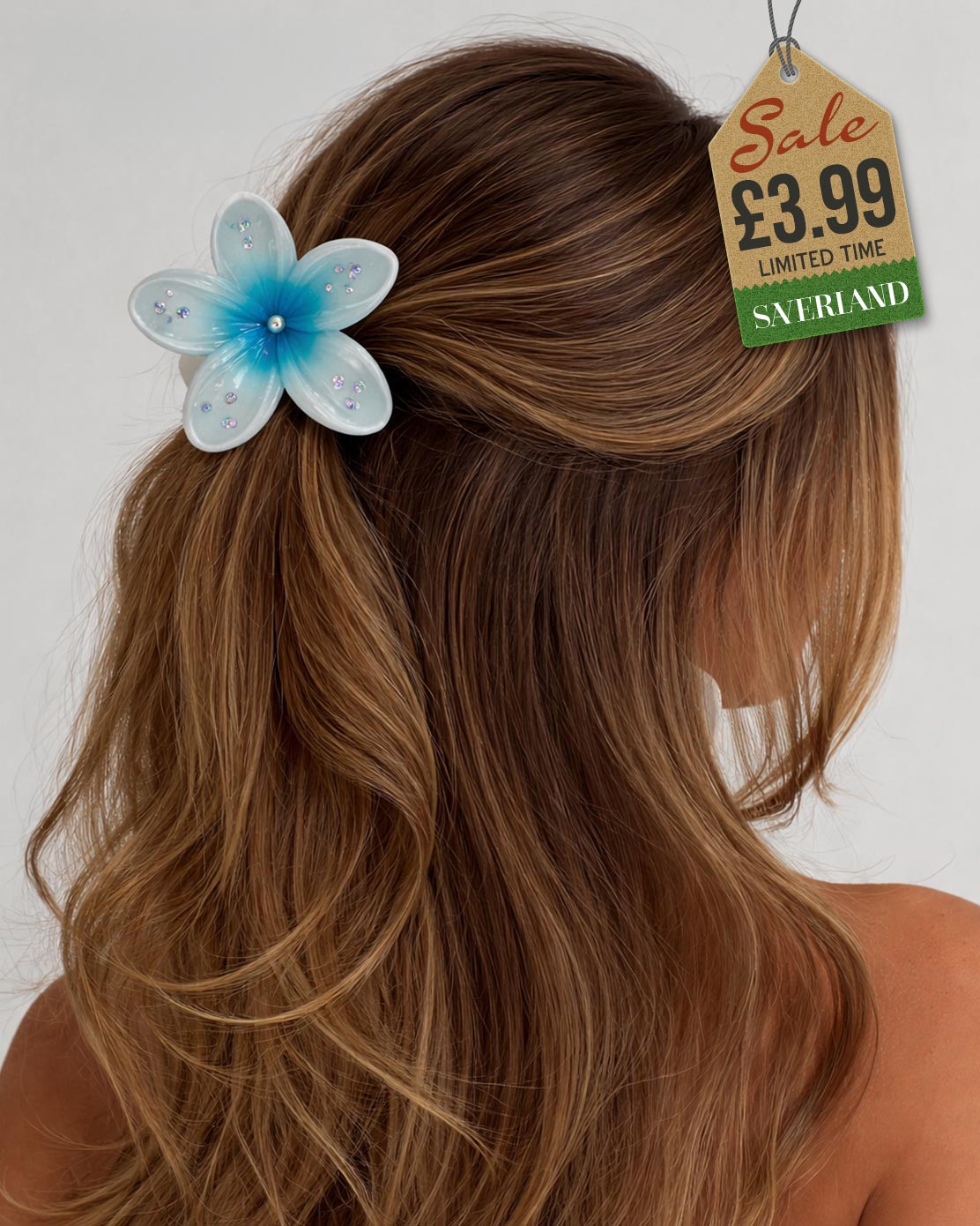 Blue sparkle flower hair clip with rhinestones worn in brown hair