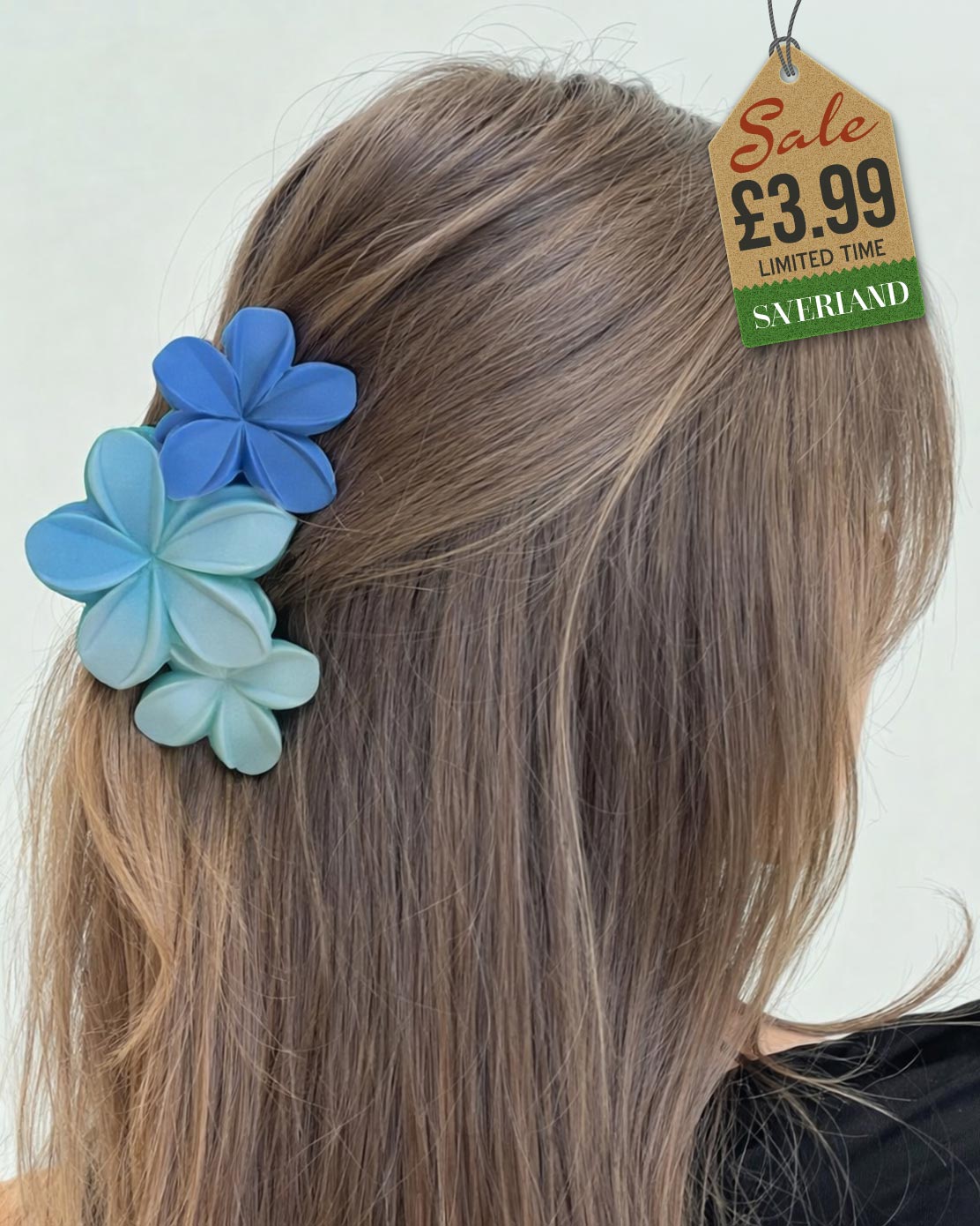 Twin blue plumeria flower hair clip in long hair