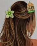 Green sparkle flower hair clip with rhinestones in long hair