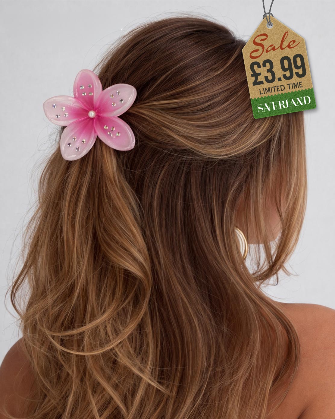 Pink sparkle flower hair clip with rhinestones in brown hair