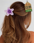 Purple sparkle flower hair clip with rhinestones in wavy hair
