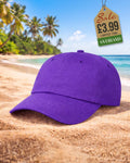 Classic plain purple six-panel baseball cap on sand at a tropical beach