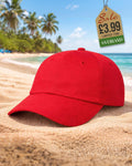 Classic plain red six-panel baseball cap on sand at a tropical beach