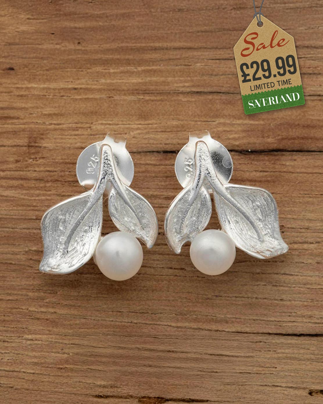 925 sterling silver brushed leaf and white pearl stud earrings on a wooden surface