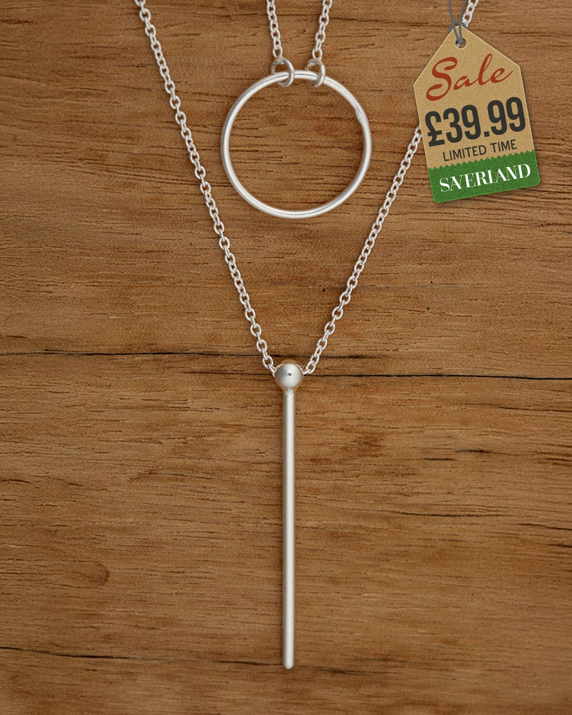 Silver-tone lariat necklace with open circle pendant and long bar drop on a cable chain