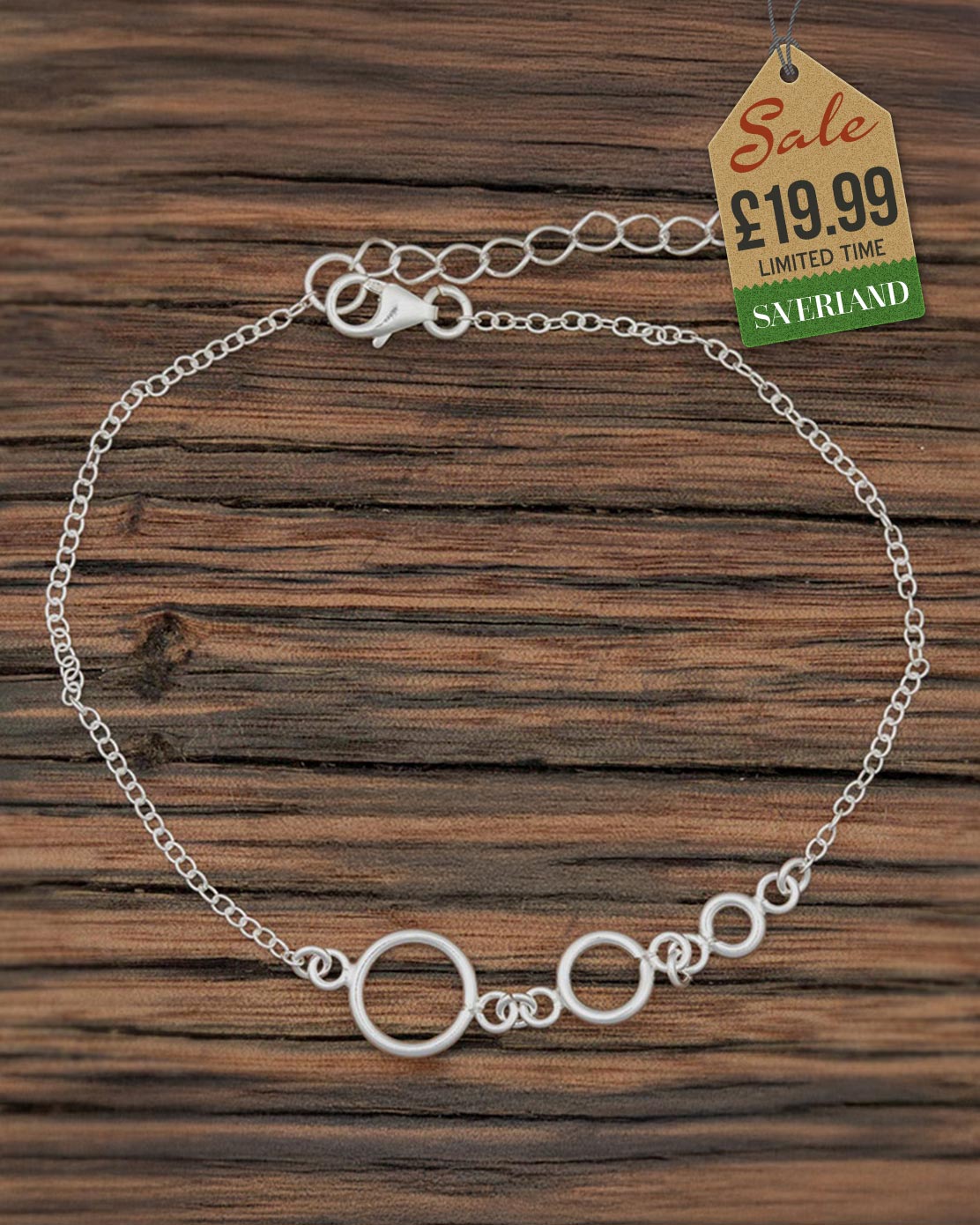 Silver chain bracelet with graduated linked circles centrepiece on a wooden background