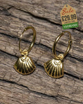 Gold-tone hoop earrings with scallop shell charm pendants displayed on rustic wood