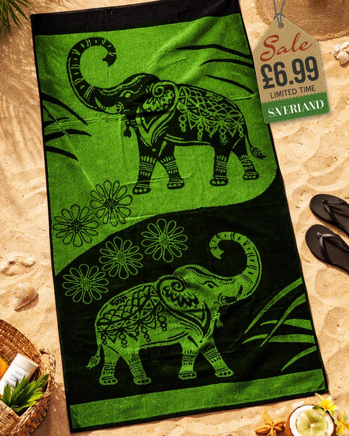 Vivid Green and black mandala elephant jacquard beach towel laid flat on sand with beach accessories