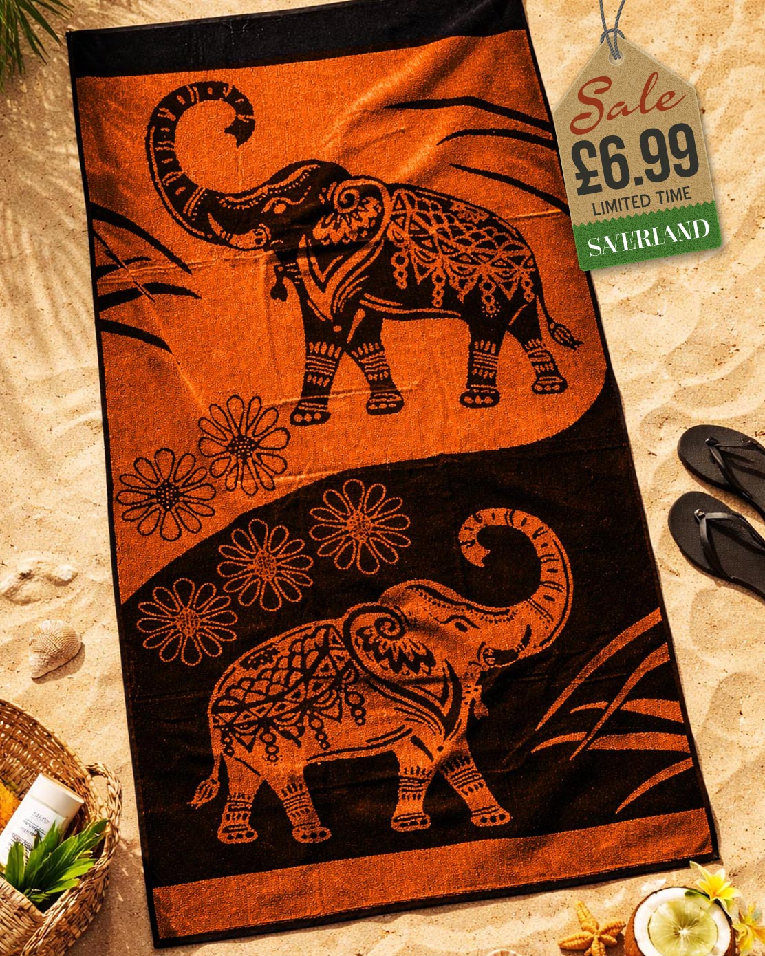 Burnt Orange and black mandala elephant jacquard beach towel laid flat on sand with beach accessories