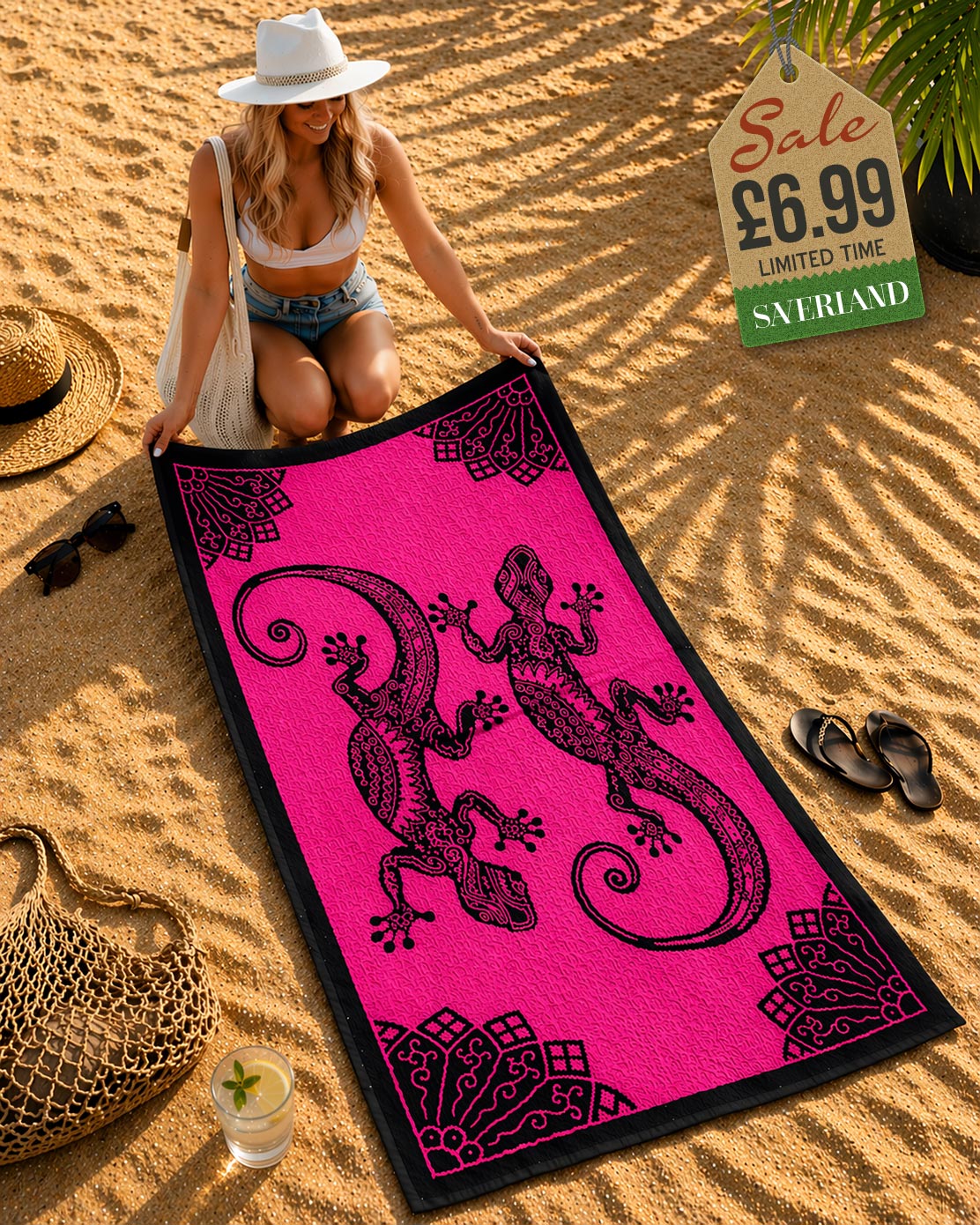 Woman laying out a hot pink and black tribal gecko beach towel on sand at beach