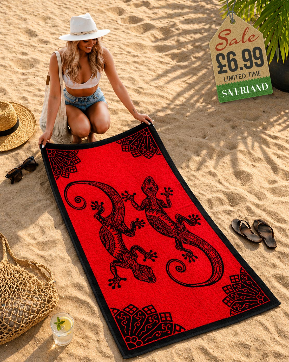 Woman laying out a red and black tribal gecko beach towel on sand at beach