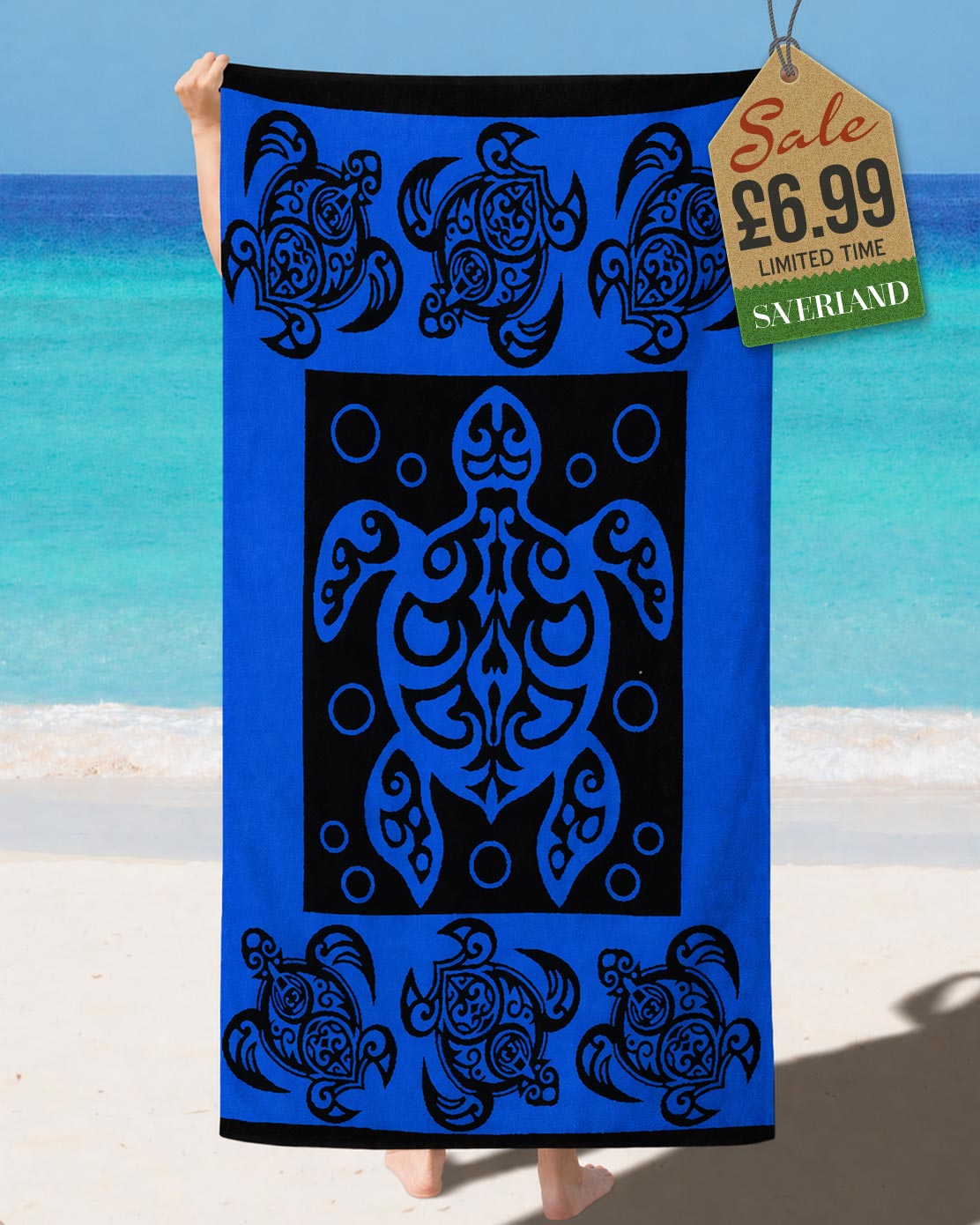 Royal Blue and black tribal Polynesian sea turtle beach towel held up at the beach