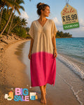 Woman wearing a dip-dye kaftan beach dress in beige and fuchsia pink, walking barefoot on a sandy beach