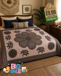 Black and white mandala elephant bed throw draped over a double bed in a boho bedroom setting
