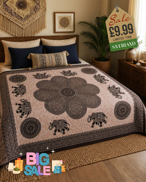 Black and white mandala elephant bed throw draped over a double bed in a boho bedroom setting