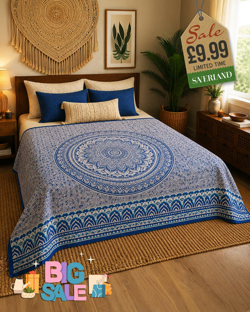 Blue and cream mandala print bed throw draped over a double bed in a bohemian bedroom setting