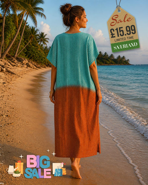 Woman walking on a tropical beach wearing a colour block kaftan maxi dress in teal and rust brown with short sleeves