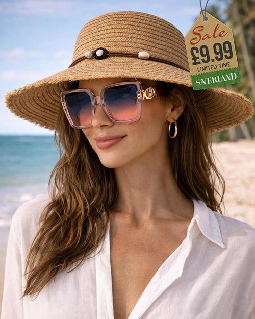 Woman wearing chic pink oversized sunglasses with gold accents at tropical beach with shell-trimmed straw hat
