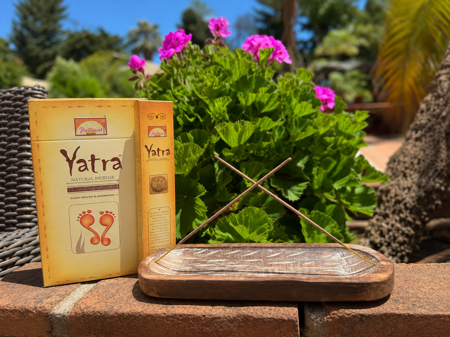 Parimal Yatra Natural Incense box with carved wooden incense holder and crossed incense sticks, displayed outdoors