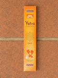 Yatra Natural Incense Sticks by Padma in orange packaging laid flat on terracotta tiles
