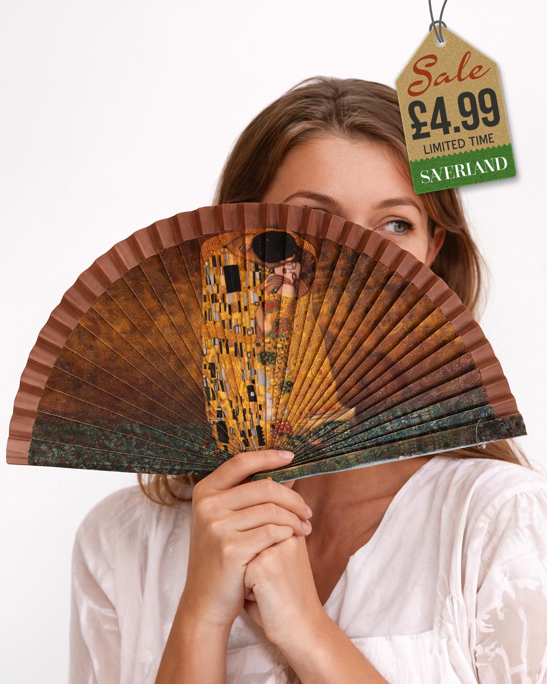 Folding hand fan with a print inspired by The Kiss by Gustav Klimt with warm brown frame held by woman