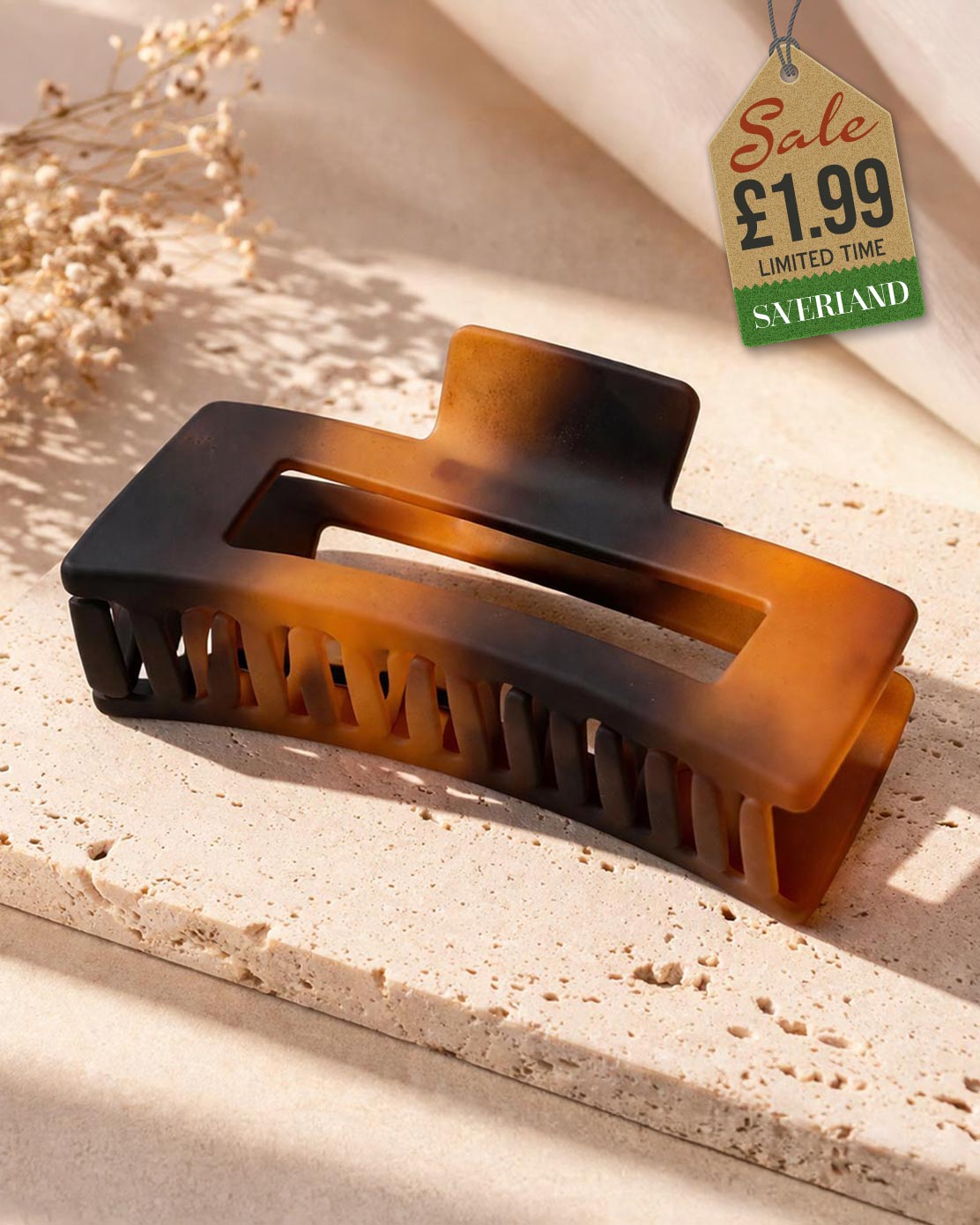 Large rectangular tortoiseshell claw clip on travertine tile