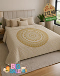 Old gold and white mandala bed throw draped over a double bed in a bright bedroom