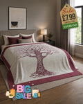 Cream fleece throw blanket with burgundy Tree of Life print and matching border, draped over a bed