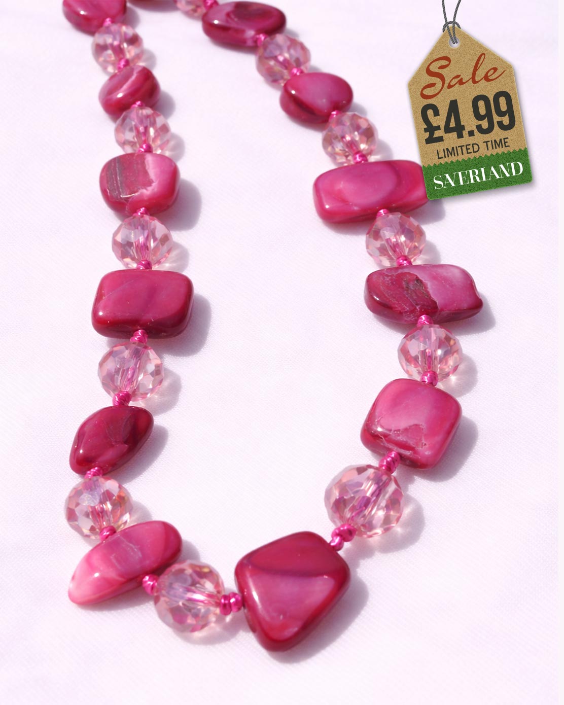 Rose pink shell chip and clear crystal faceted bead necklace - flat product view on pink background