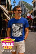 Man wearing a royal blue t-shirt with a black and white manga comic panel graphic, standing on a Gibraltar street