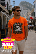 Man wearing an orange t-shirt with a dark abstract ink splash graphic print featuring a lone figure and swirling smoke, photographed on Main Street Gibraltar