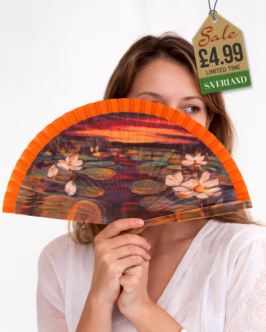 Folding hand fan with an impressionist water lilies art print with vivid orange frame held by woman